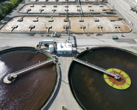 An angled aerial view of a water treatment plant and tanks.
