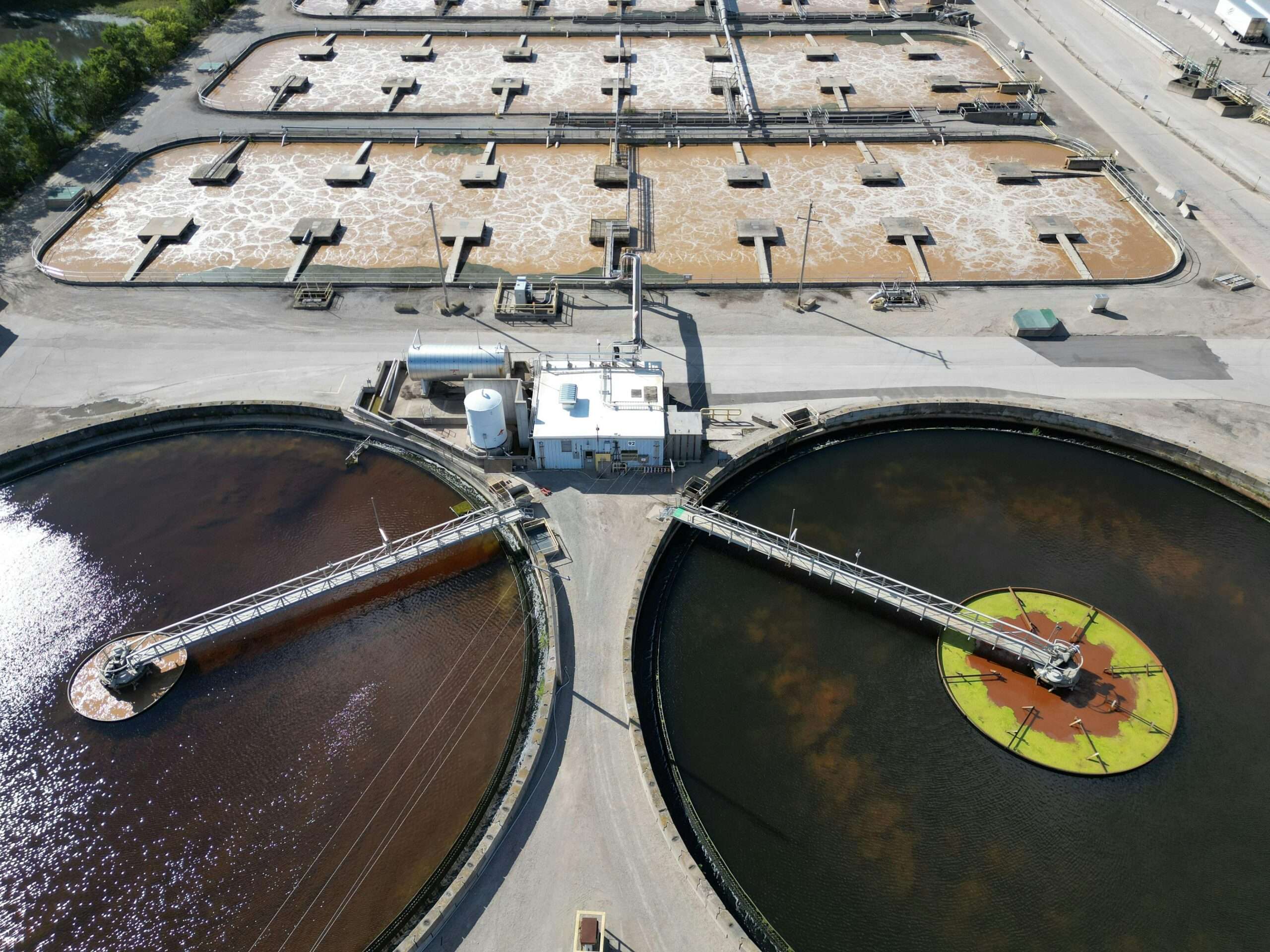 An angled aerial view of a water treatment plant and tanks.