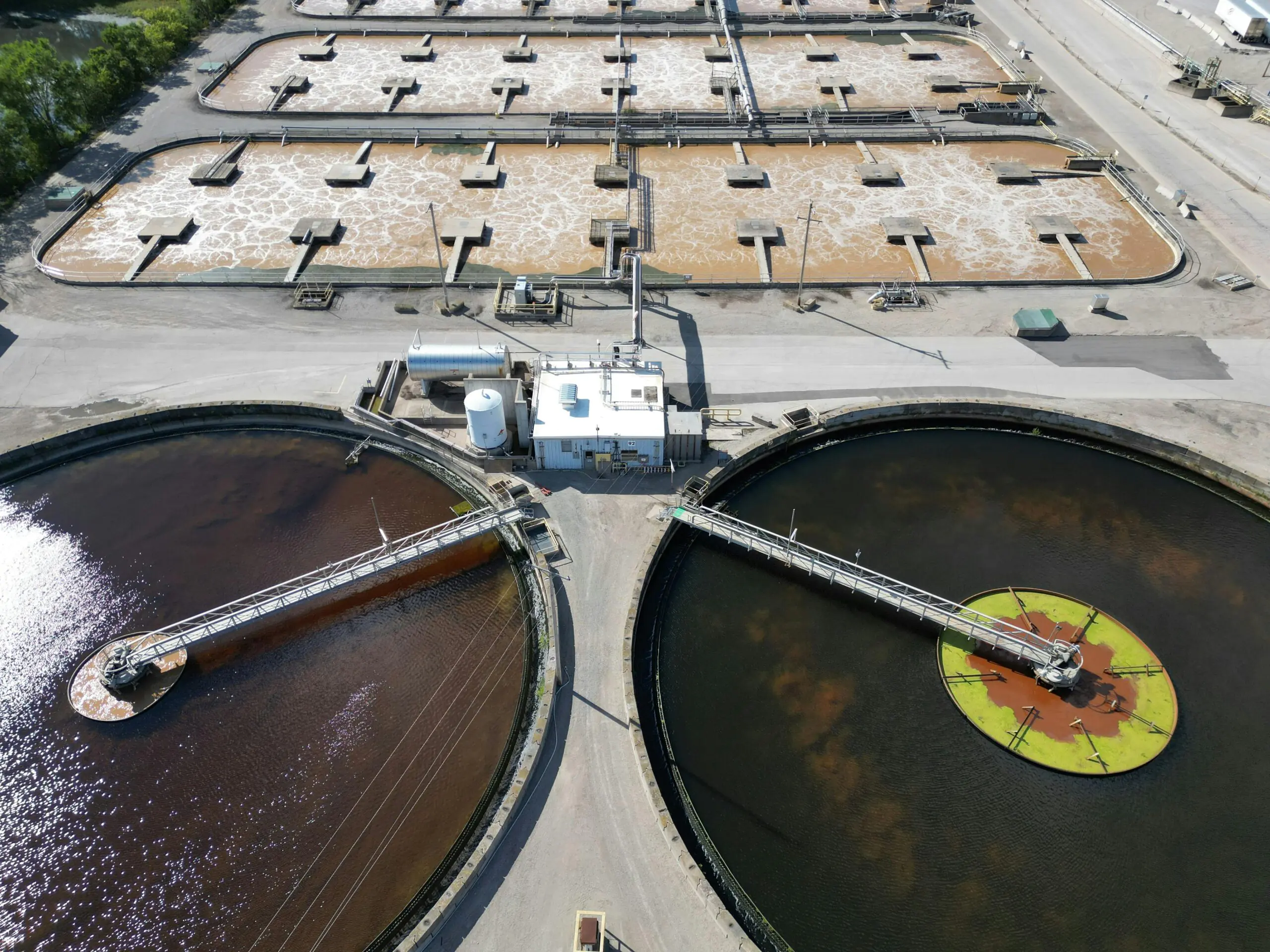 An angled aerial view of a water treatment plant and tanks.