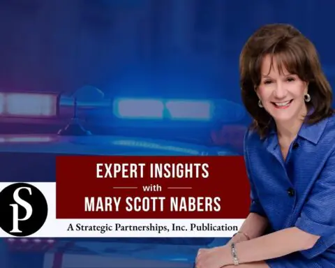 Mary Scott Nabers before a police car for her weekly column.