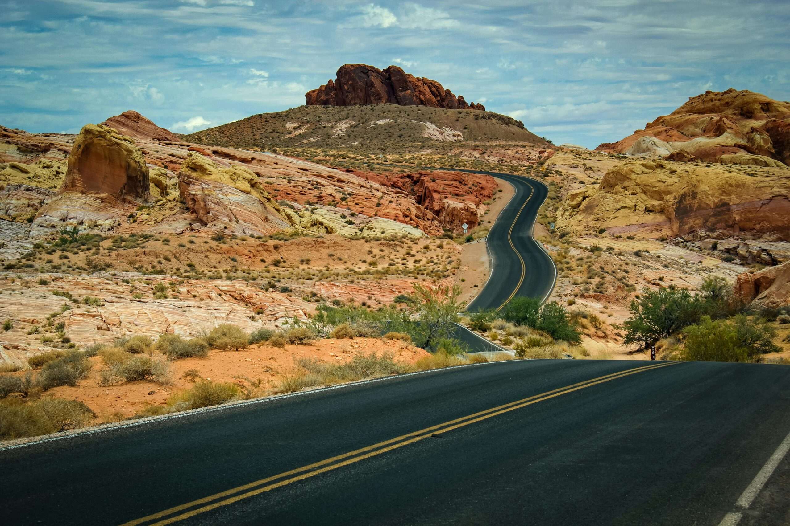 A winding highway along a desert ecosystem in Utah.