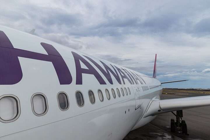 A Hawaiian Airlines plane on the tarmac of a Hawaiian airport.