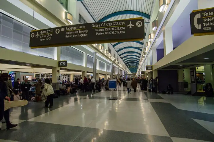 Travelers along a main terminal corridor at the Louis Armstrong New Orleans International Airport in Louisiana.