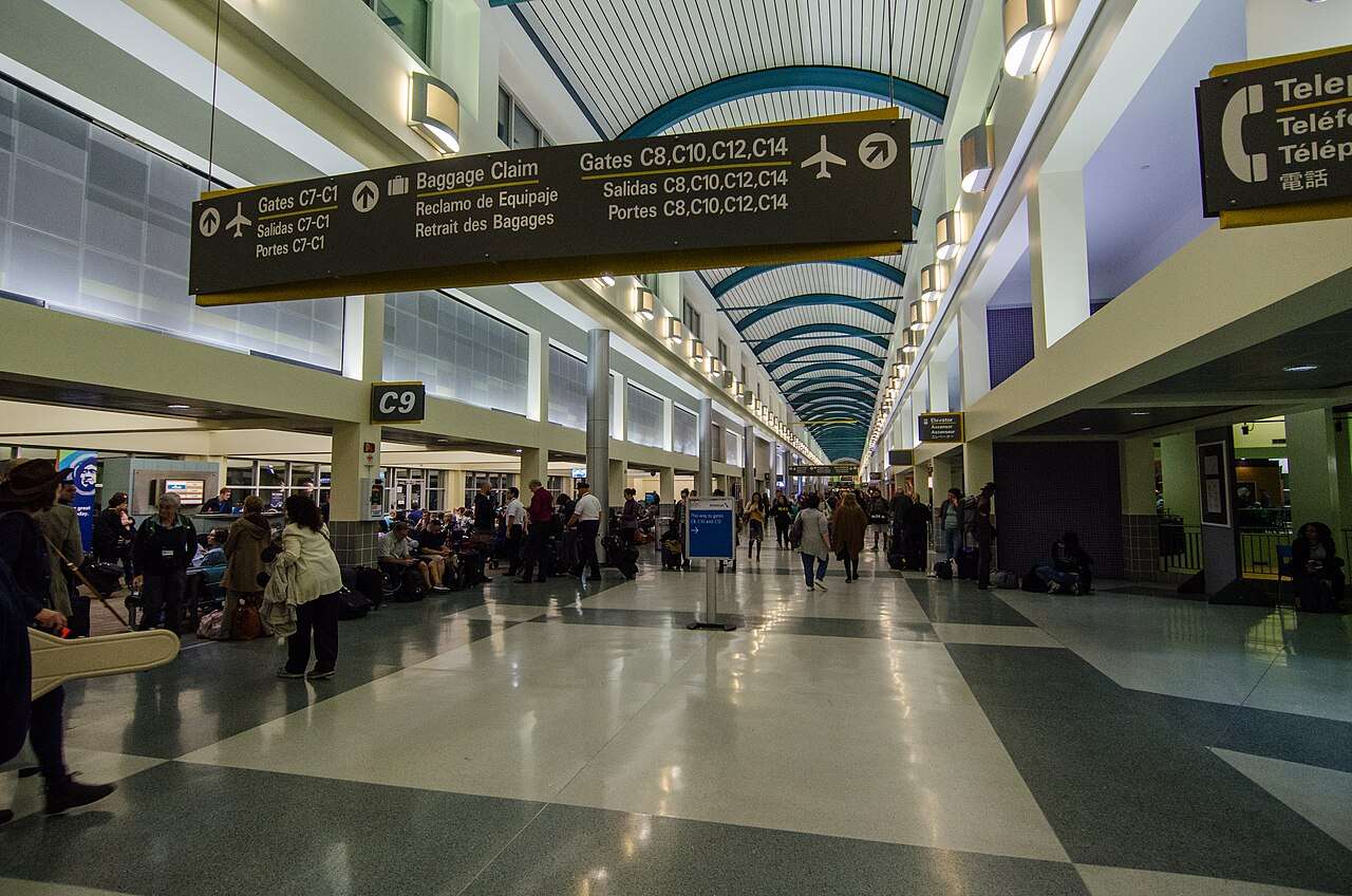 Travelers along a main terminal corridor at the Louis Armstrong New Orleans International Airport in Louisiana.