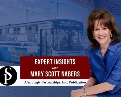 Mary Scott Nabers before a bus at a bus station for her weekly column.