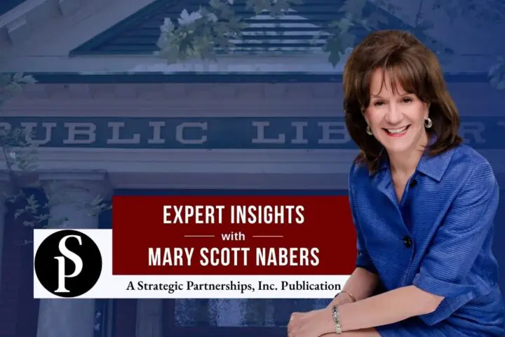 Mary Scott Nabers before a public library sign for her weekly column.