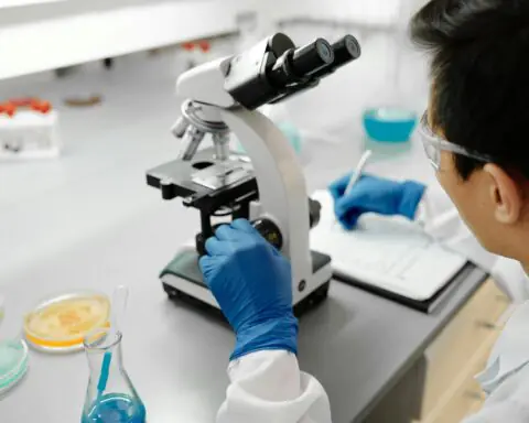A researcher looking through a microscope at a laboratory.