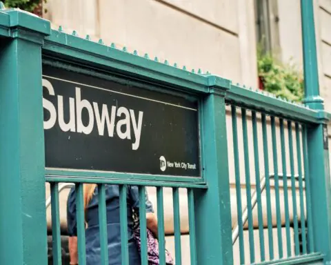 A subway sign outside of a New York City subway station.