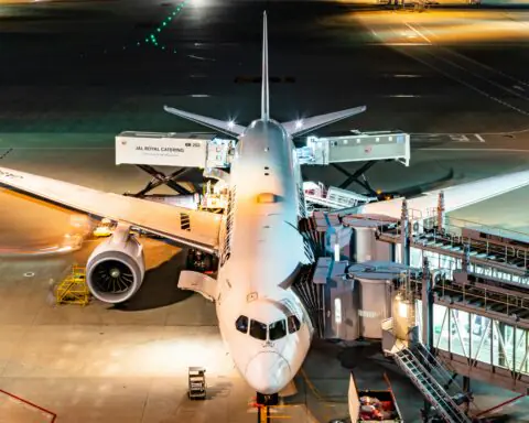 A docked plane at an airport from above.