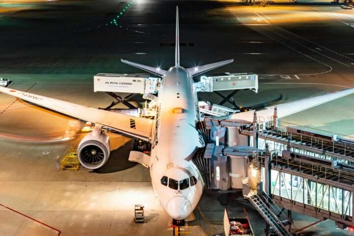 A docked plane at an airport from above.