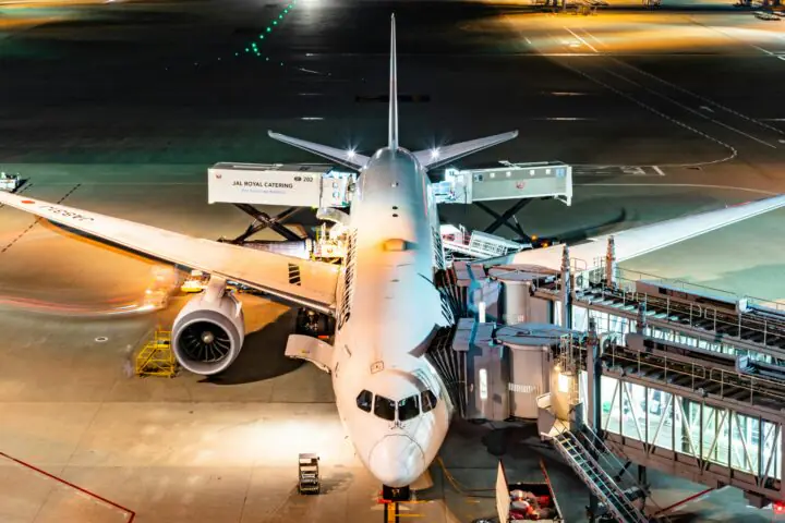 A docked plane at an airport from above.