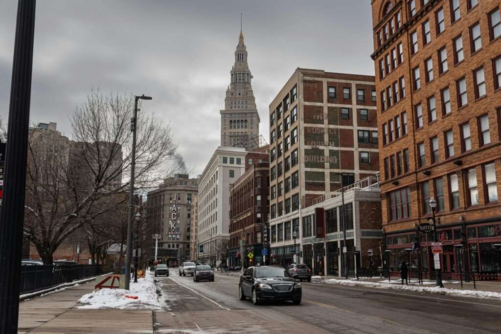 A Cleveland street with cars before city buildings.