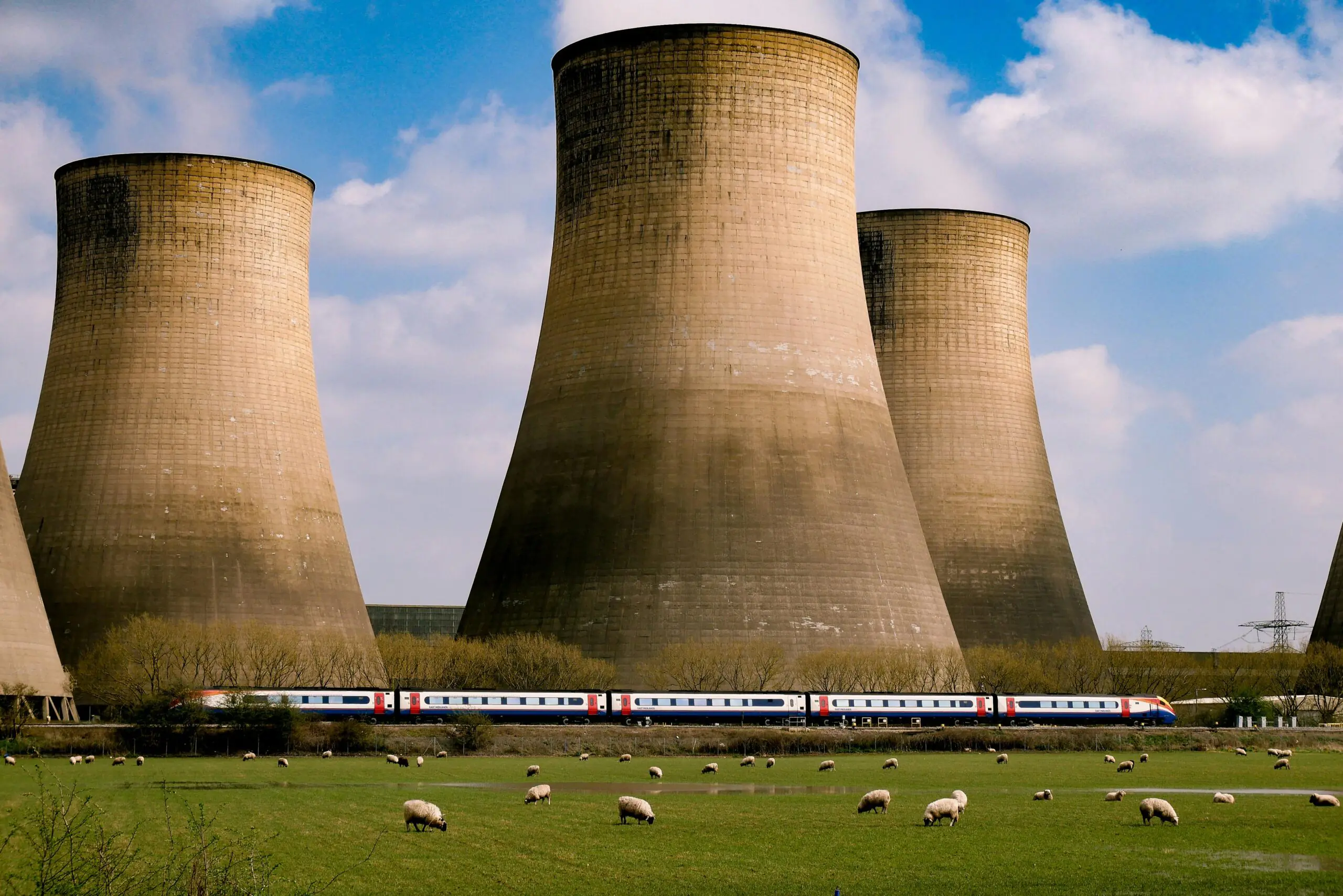 Nuclear silos before a blue cloudy sky.