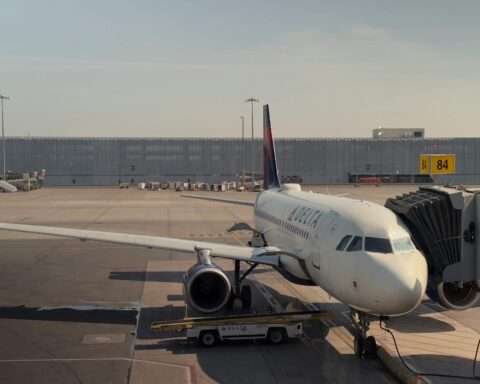 An airplane at an airport along the runway.