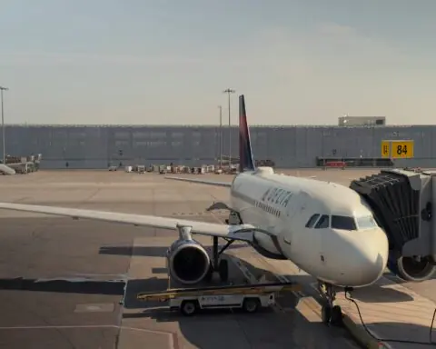 An airplane at an airport along the runway.