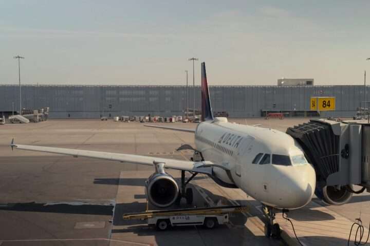 An airplane at an airport along the runway.