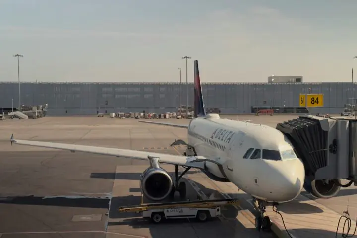 An airplane at an airport along the runway.