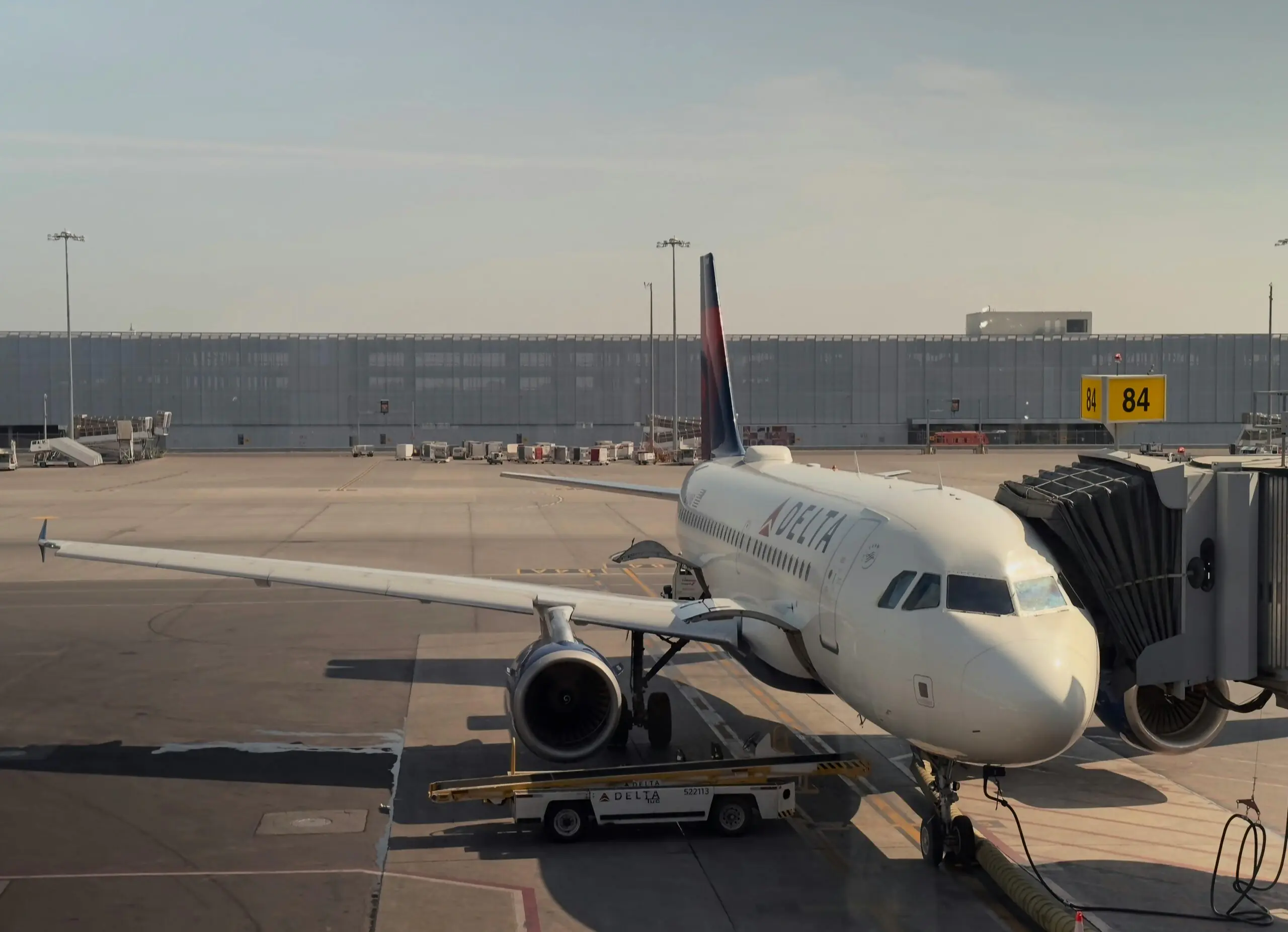 An airplane at an airport along the runway.