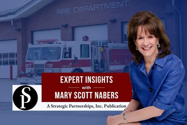 Mary Scott Nabers before a fire truck and station for her weekly column.
