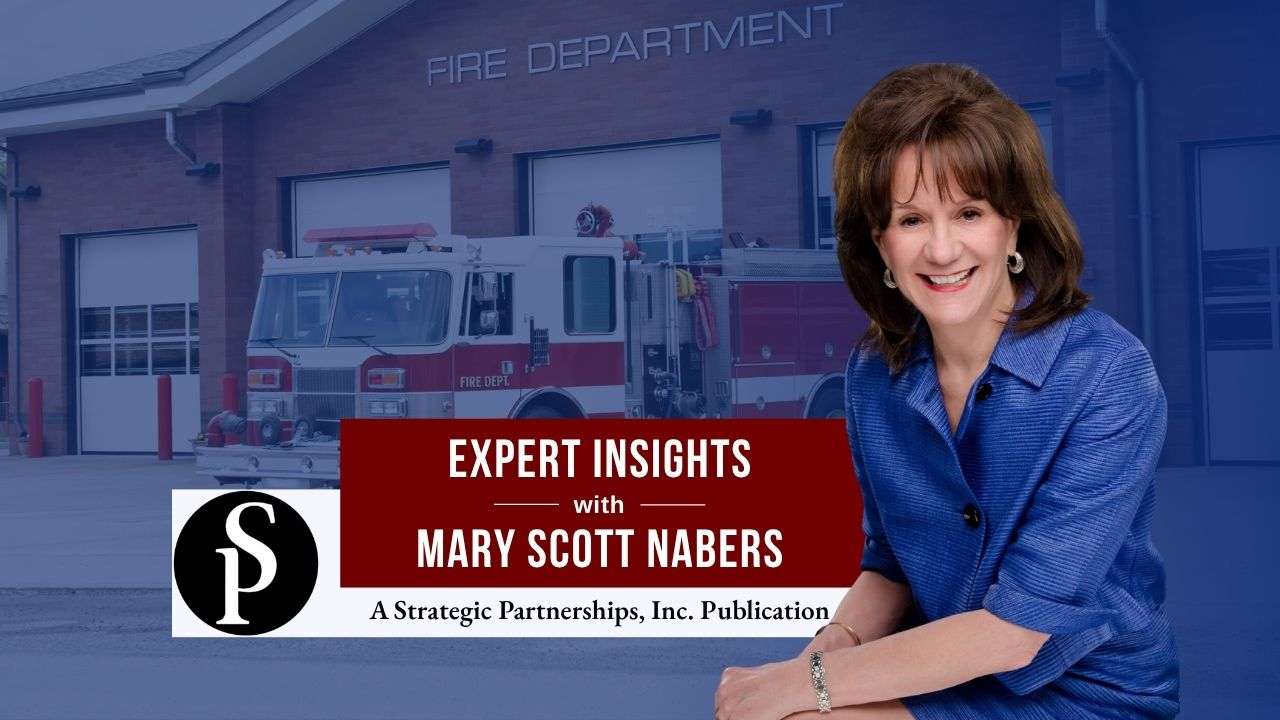 Mary Scott Nabers before a fire truck and station for her weekly column.