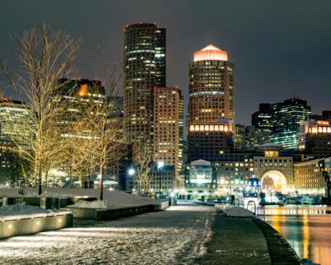 The Boston skyline at night with snow.