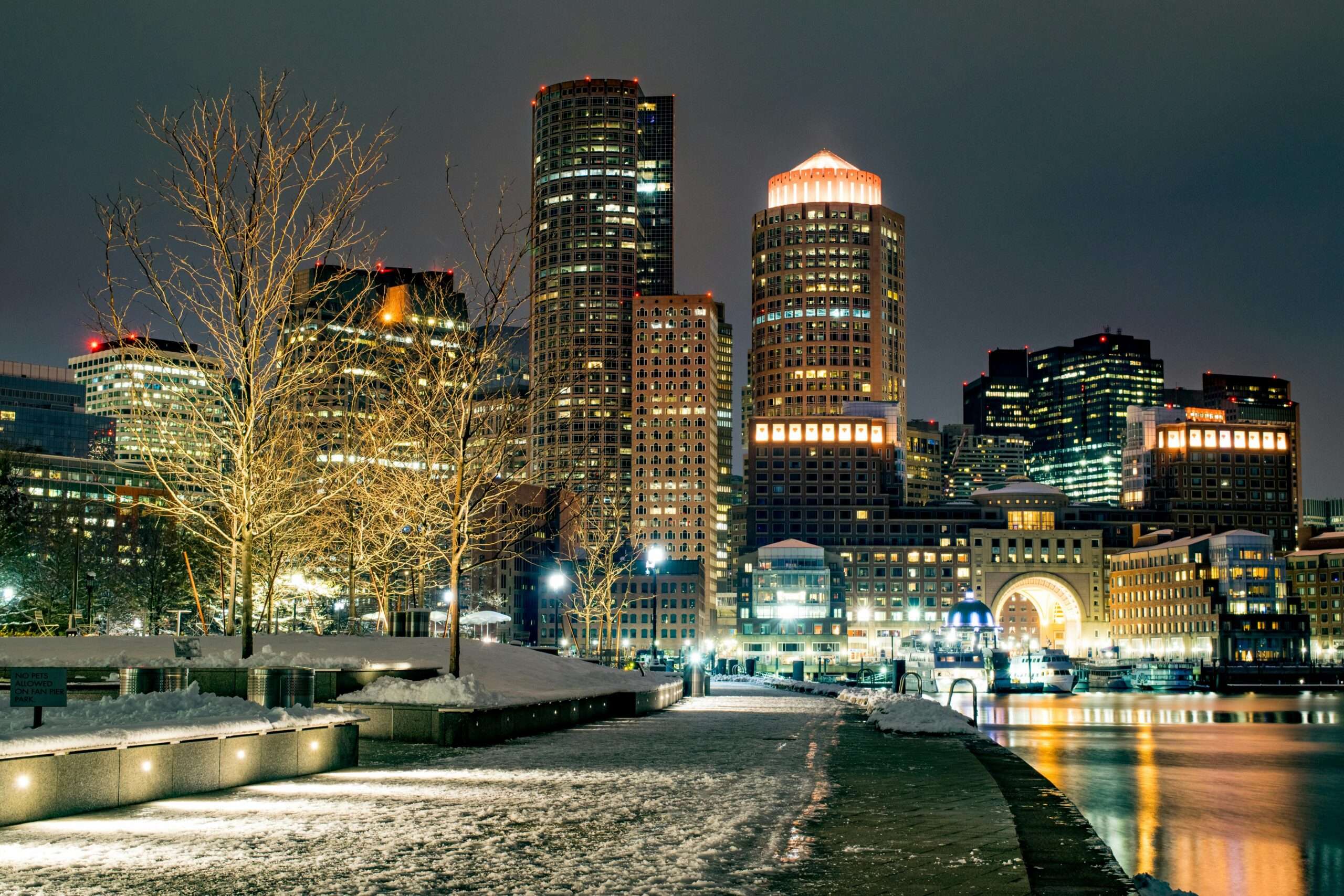 The Boston skyline at night with snow.