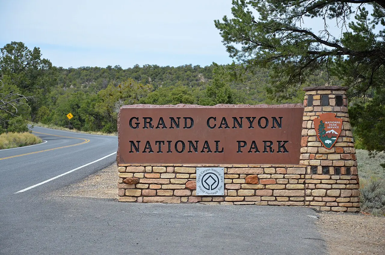 Along Highway 64, the East Entrance sign welcomes visitors to Grand Canyon National Park. Then, they are met by a set of drive-through entrance booths clad with arcing stone walls, recalling the construction of the Desert View Watchtower, in a modern interpretation that incorporates exposed steel columns and beams. NPS Photo by Michael Quinn.