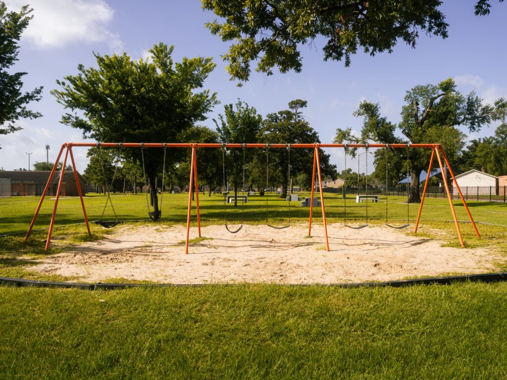 A swing set at a local park in the daytime.