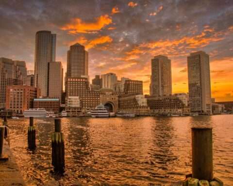 The Boston coast before a orange sunlit sky.